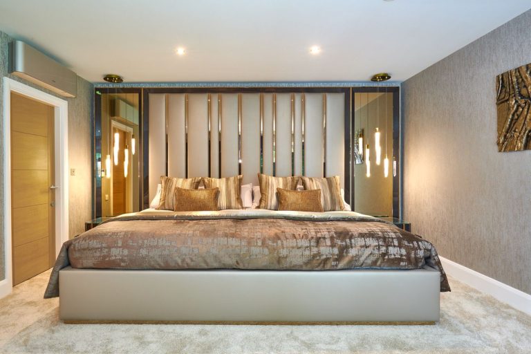Master bedroom with a nine foot bespoke bed and a full-wall headboard