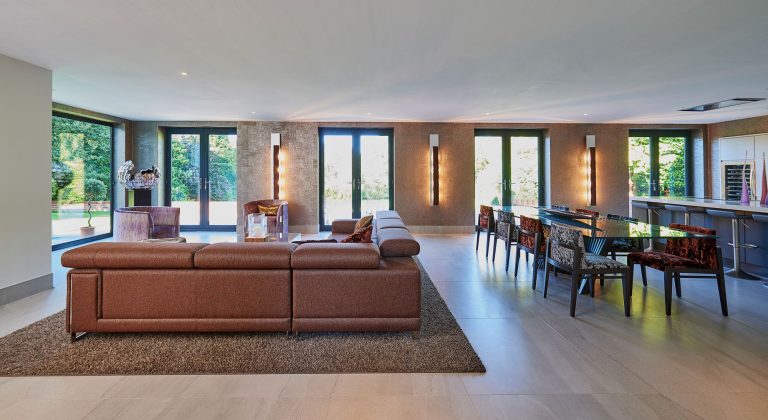 Open-plan living and dining room with garden doors along one wall