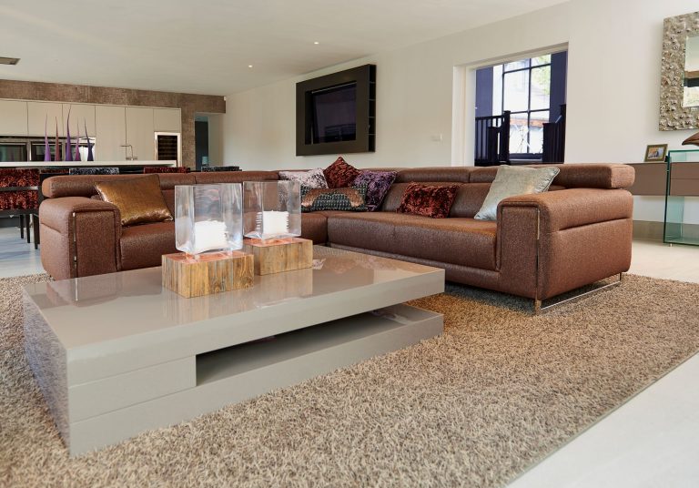 Living room with a marble coffee table and the open kitchen beyond