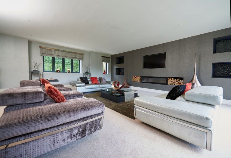 Living room with a copper sculpture and red accents