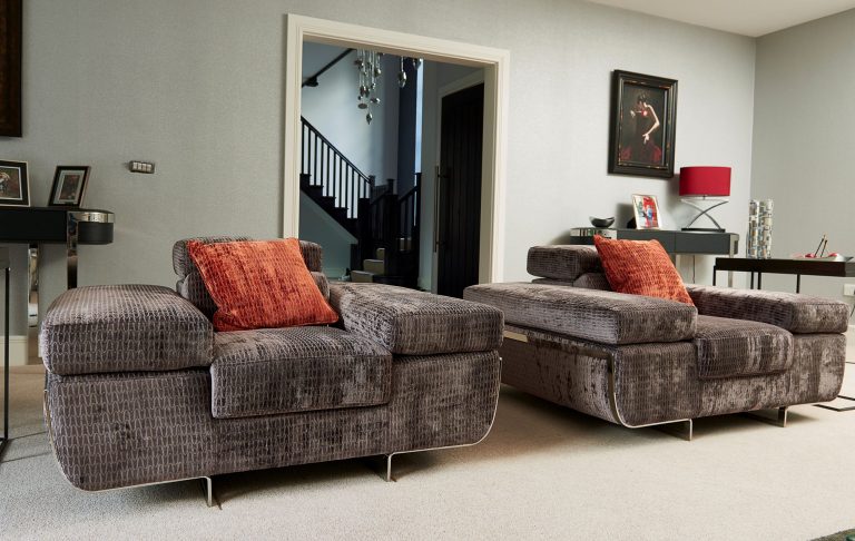 Snug with velvet armchairs and a view through to the hall
