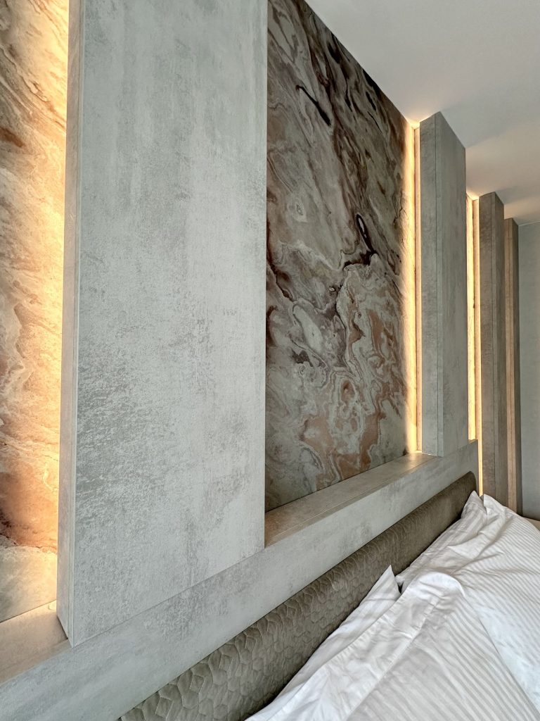 The lit headboard wall providing the mood lighting in the evening