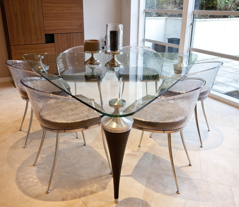 Triangular glass dining table with Perspex dining chairs