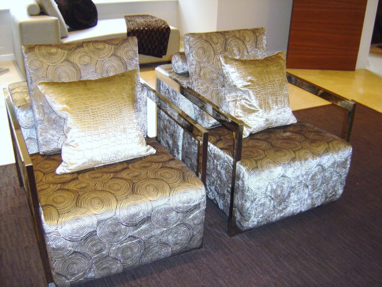 Occasional chairs in patterned velvet beside the sofa