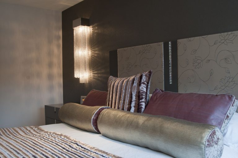 Textured wall covering and bolster cushions in the master bedroom