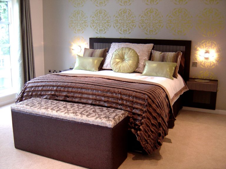 Patterned wall covering in a guest bedroom with bespoke oak furniture