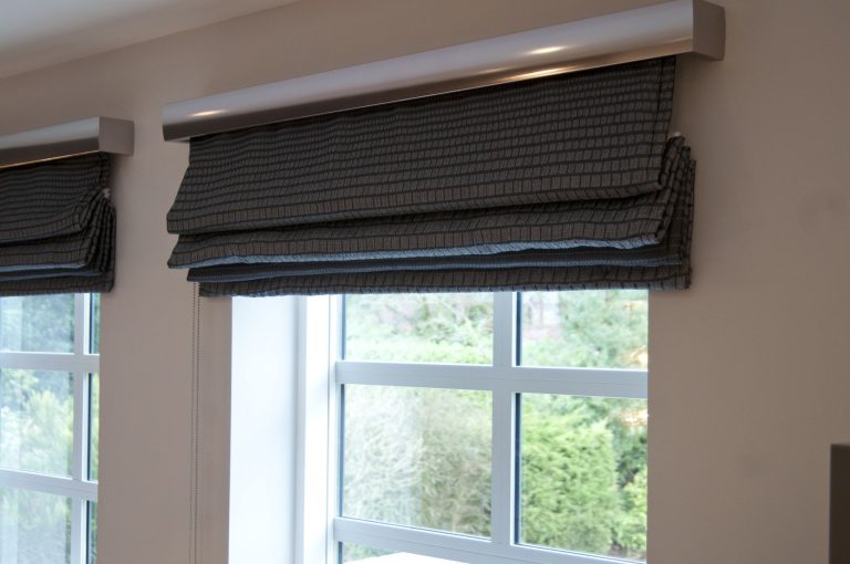 Roman blind in a textured weave, stacked clear of the glass
