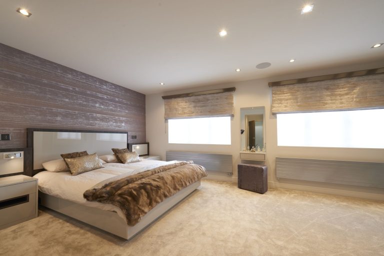 Textured wall covering running behind a bed in a new build