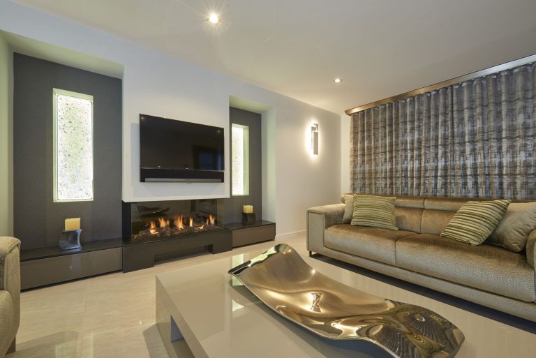 Woven curtain fabric beside a linear fire in a sitting room