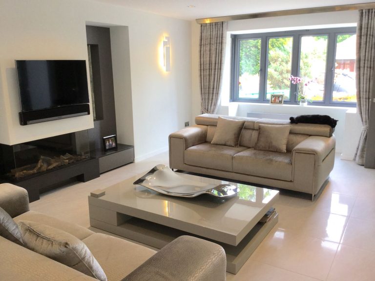 Living room with a fire, a television and a window seat