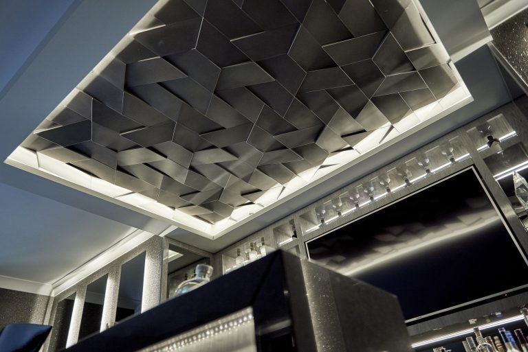 Three-dimensional ceiling panel above the basement bar