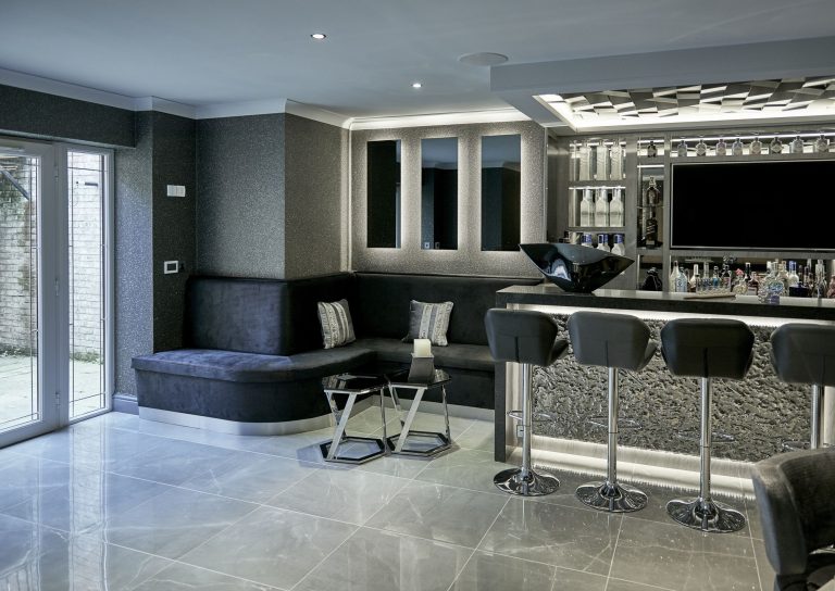 Basement seating area with the bar and the television wall