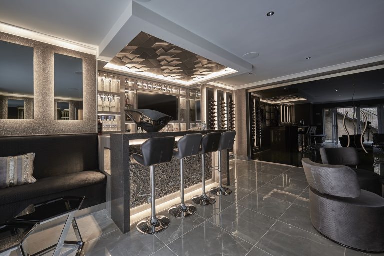 The bar seen along the basement with seating beyond