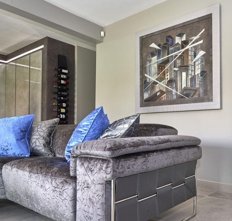 Living area with framed artwork above the sofa