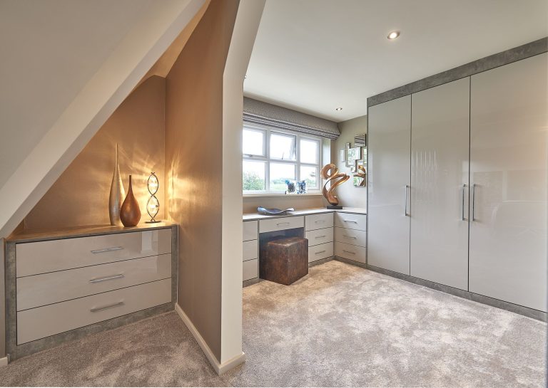 Dressing room with fitted wardrobes and a dressing table