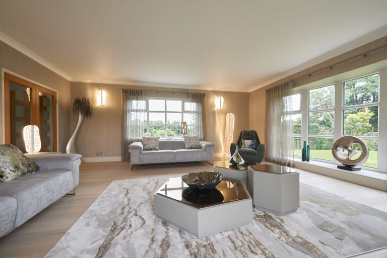 Sheer curtains at full-height windows in a cottage lounge