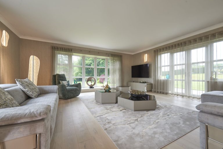 Living room with a wall-hung television and sculptural floor lights